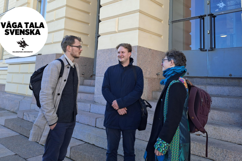 Personnel and students at the University of Helsinki discuss in front of the Main building.